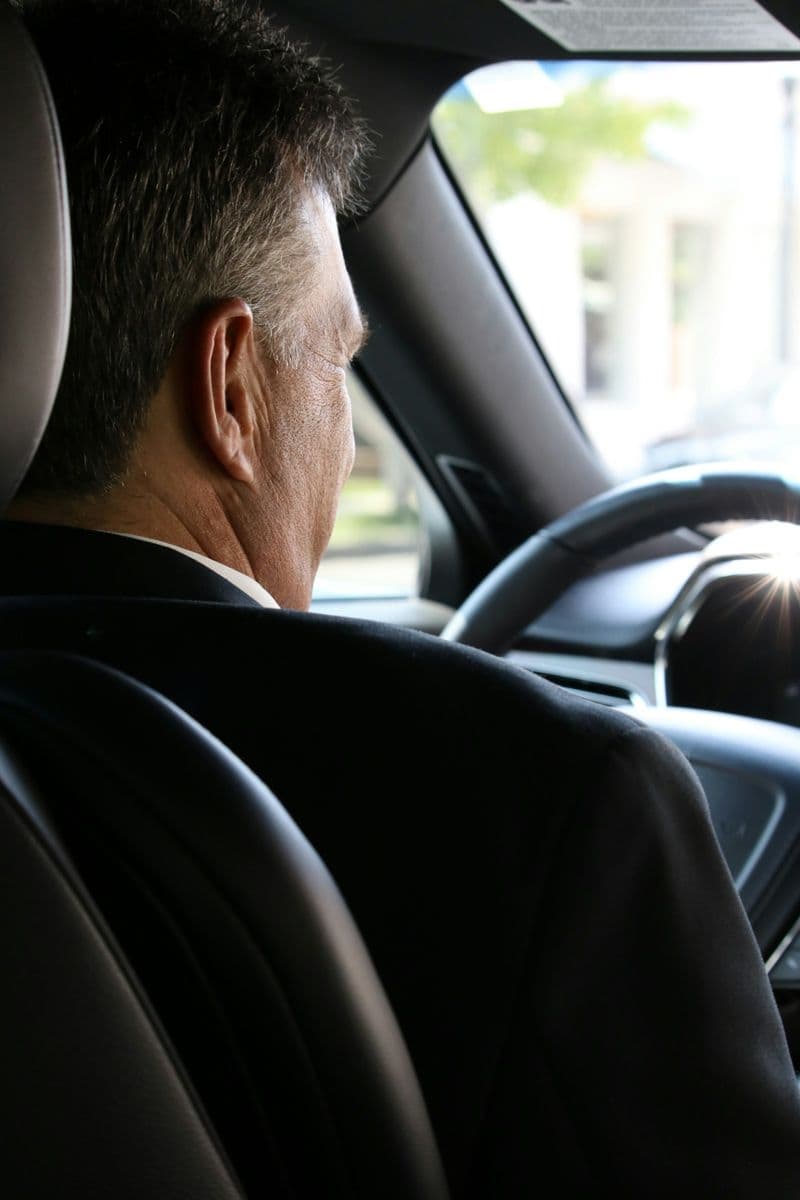 A chauffeur driving a car