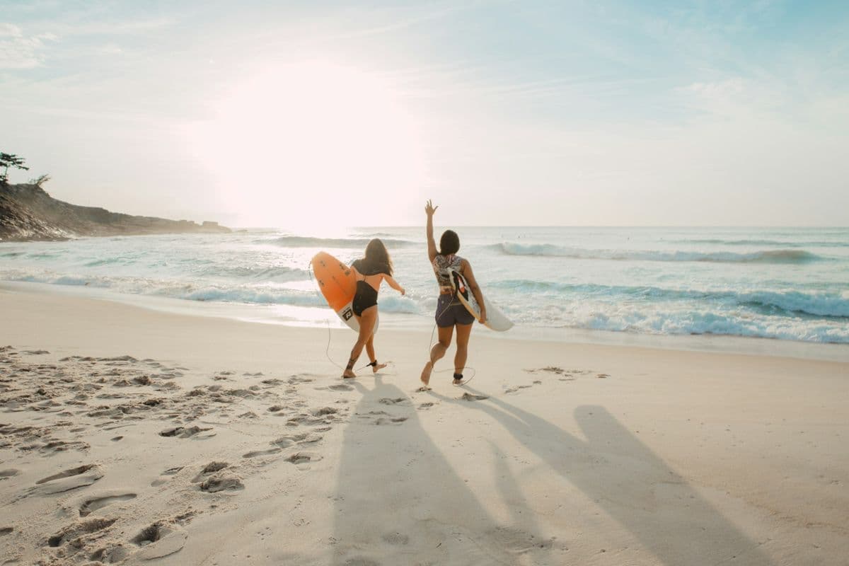 A couple running towards the sea