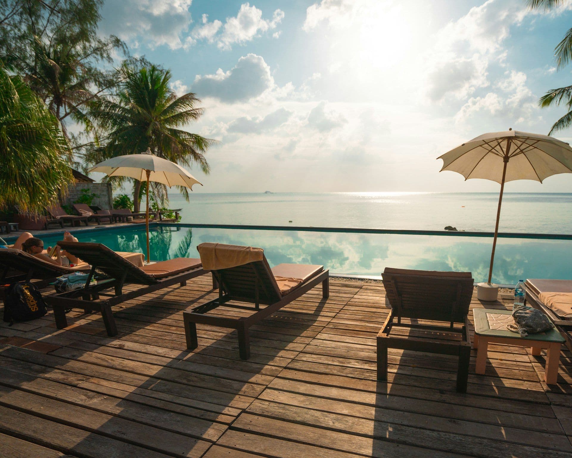 Sun loungers by a pool facing the sea